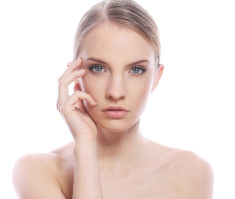 Portrait of beautiful woman with clean face over white background