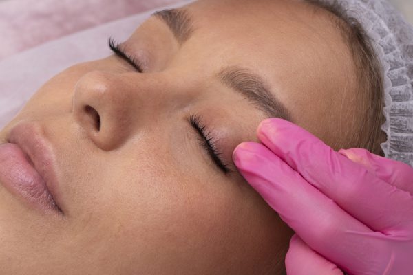 high-angle-woman-eyelashes-extension-application